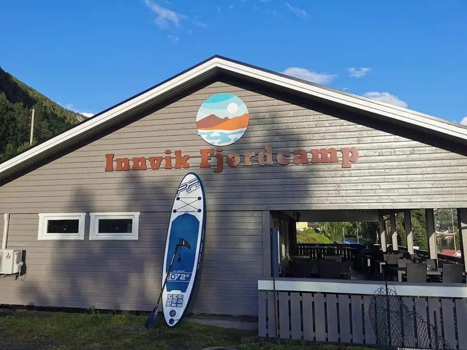 Innvik Fjordcamp main building with SUP board
