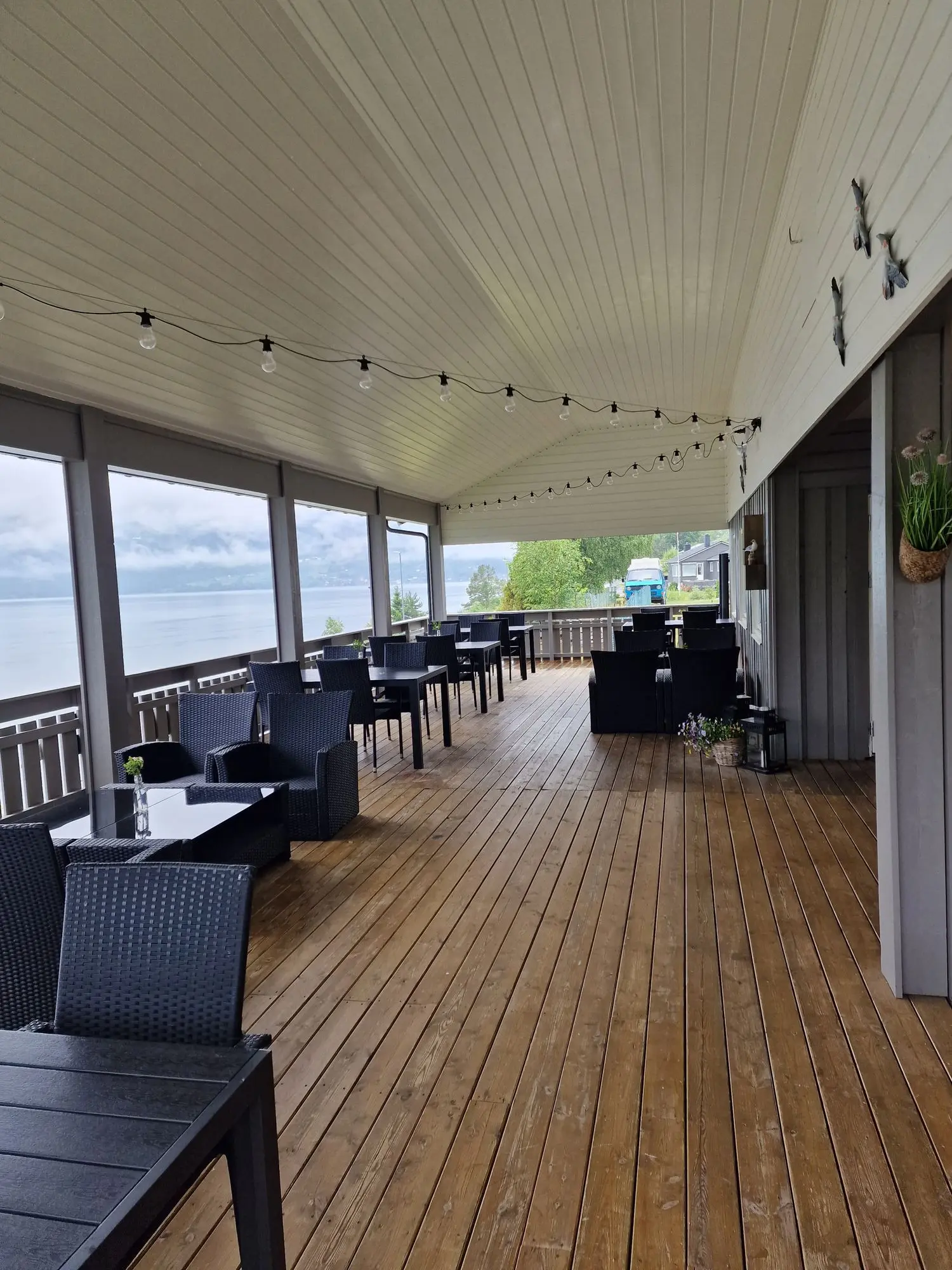 Restaurant terrace with string lights overlooking the Nordfjord